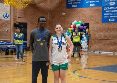 A photo of the two WSBC MVPs standing in the ASDB gymnasium. On the left is the Boys MVP, Phoenix Roadrunner Kotu Salih. On the right is the Girls MVP, Washington Terrier Ashley Andersen.